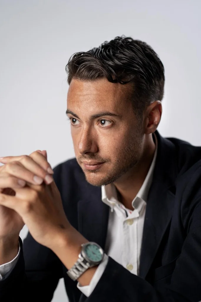 Portrait of a man in suit looking serious in low key lighting